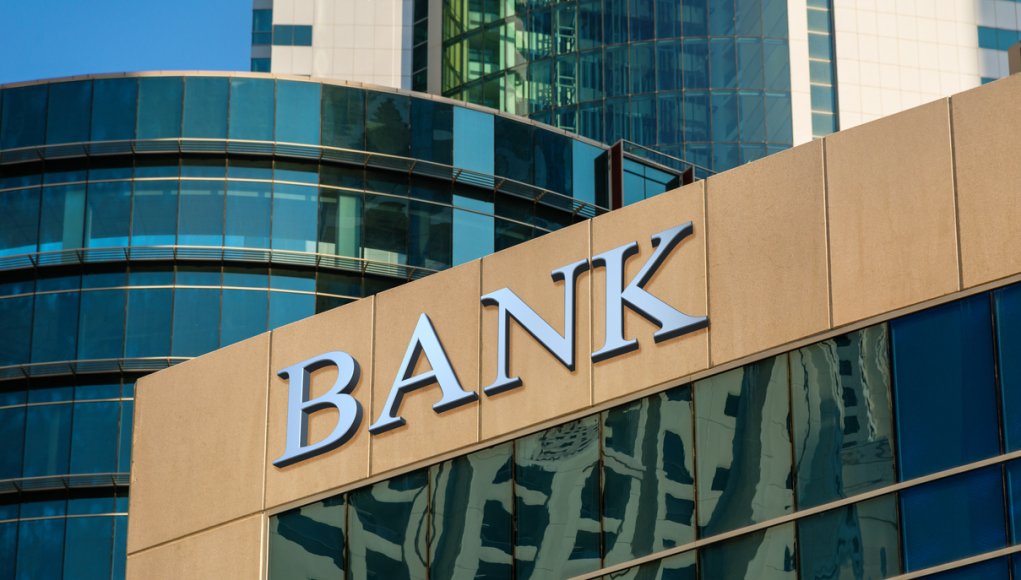 Bank sign on glass wall of business center