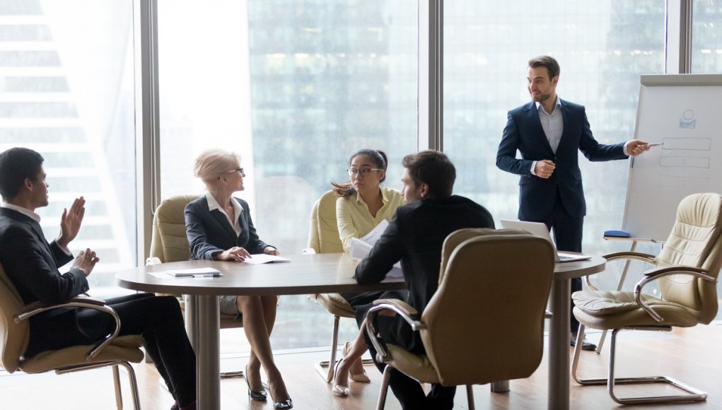 African man raising hand to ask question. Boss leader businessman presenting new project to multiracial employees colleagues during briefing Corporate training and coaching, conference seminar concept