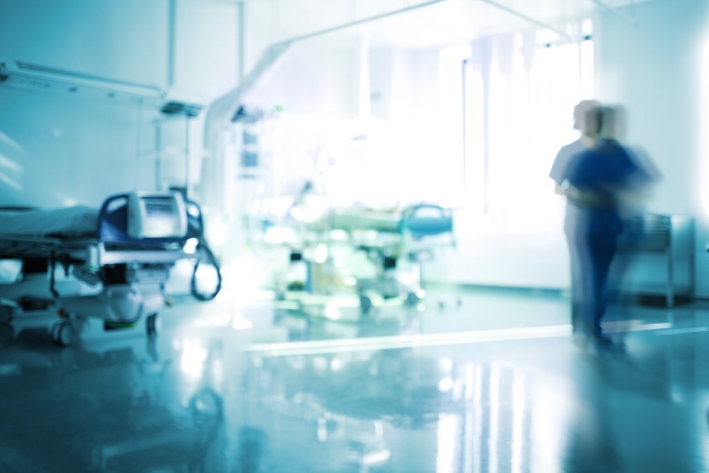 Blurred emergency room with walking staff, unfocused background