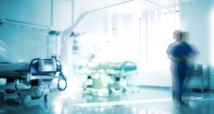 Blurred emergency room with walking staff, unfocused background