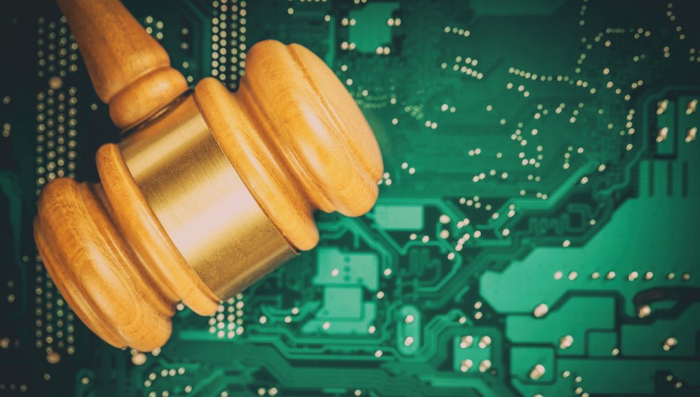 Cyber law and crime concept. Judge court gavel on computer PC motherboard