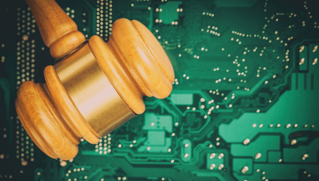 Cyber law and crime concept. Judge court gavel on computer PC motherboard