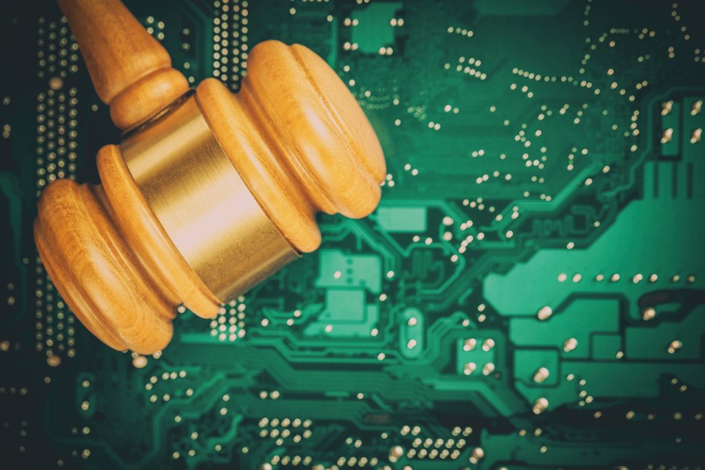 Cyber law and crime concept. Judge court gavel on computer PC motherboard