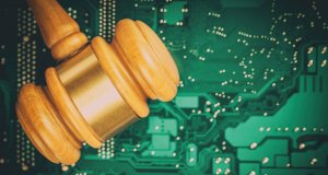 Cyber law and crime concept. Judge court gavel on computer PC motherboard