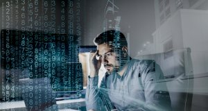 CISO staring at computer and contending with computer issue