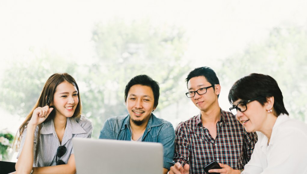 Young professionals looking at a laptop screen