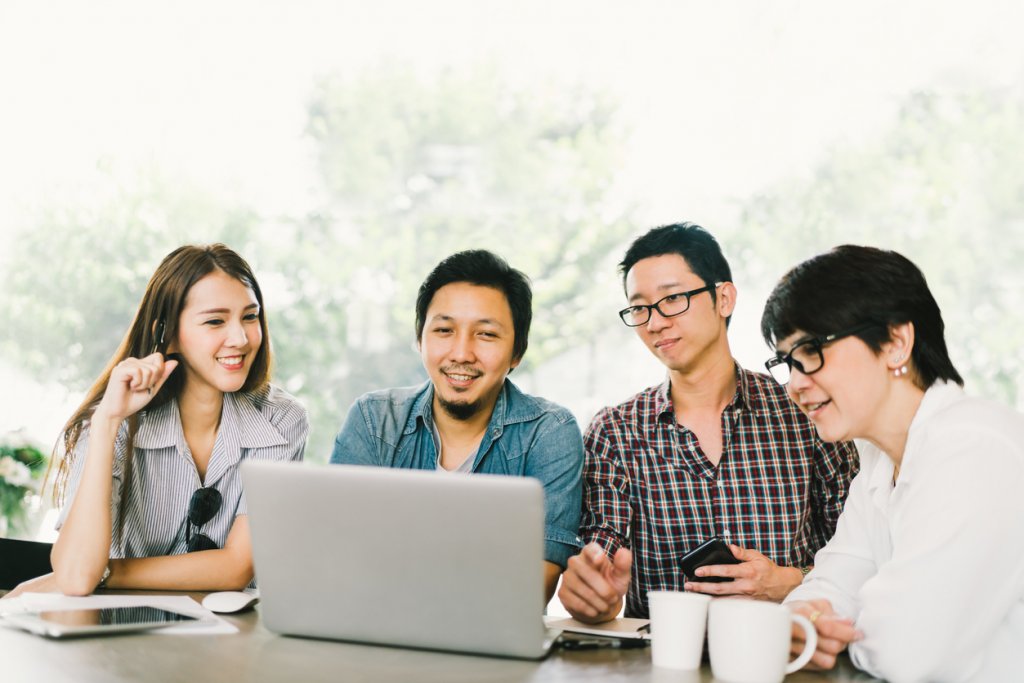 Young professionals looking at a laptop screen