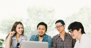 Young professionals looking at a laptop screen