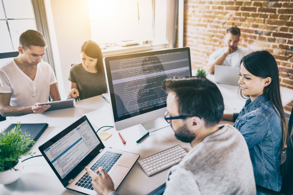 Website developers in an office setting. CISO in their midst.