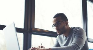 Person sitting with a laptop at a desk