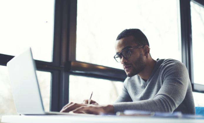 Person sitting with a laptop at a desk