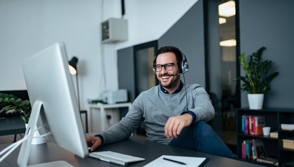 Smiling businessman online working from home