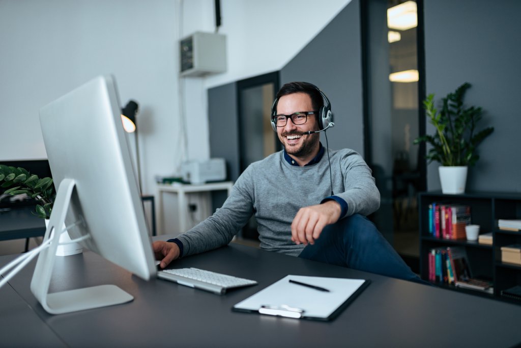 Smiling businessman online working from home