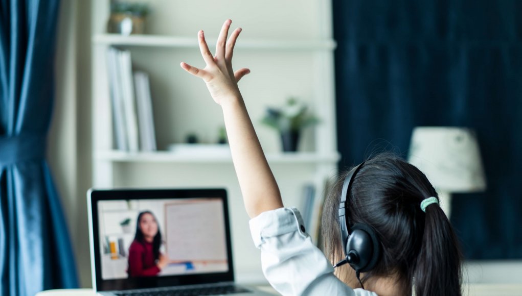 Online school concept, girl raises hand