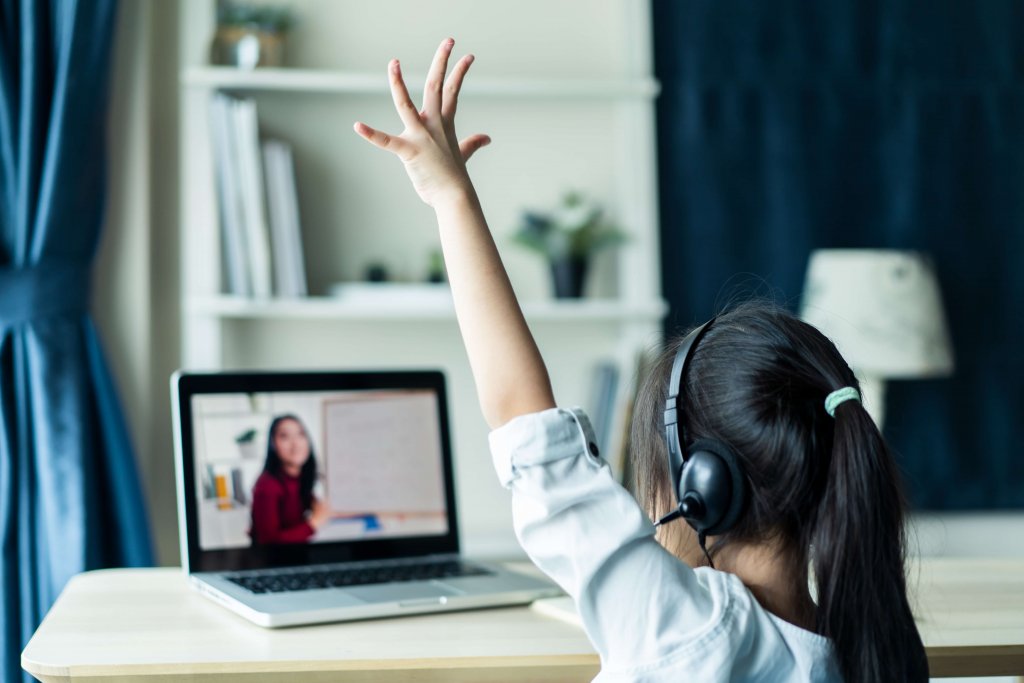 Online school concept, girl raises hand