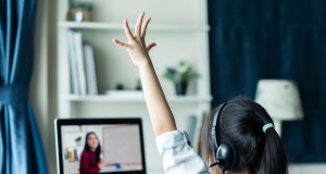 Online school concept, girl raises hand