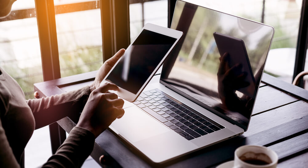 Employee on laptop and iPad