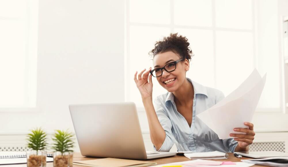 Worker at desk, smiling