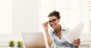 Worker at desk, smiling