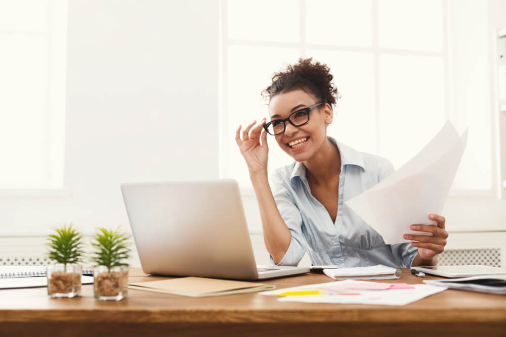 Worker at desk, smiling