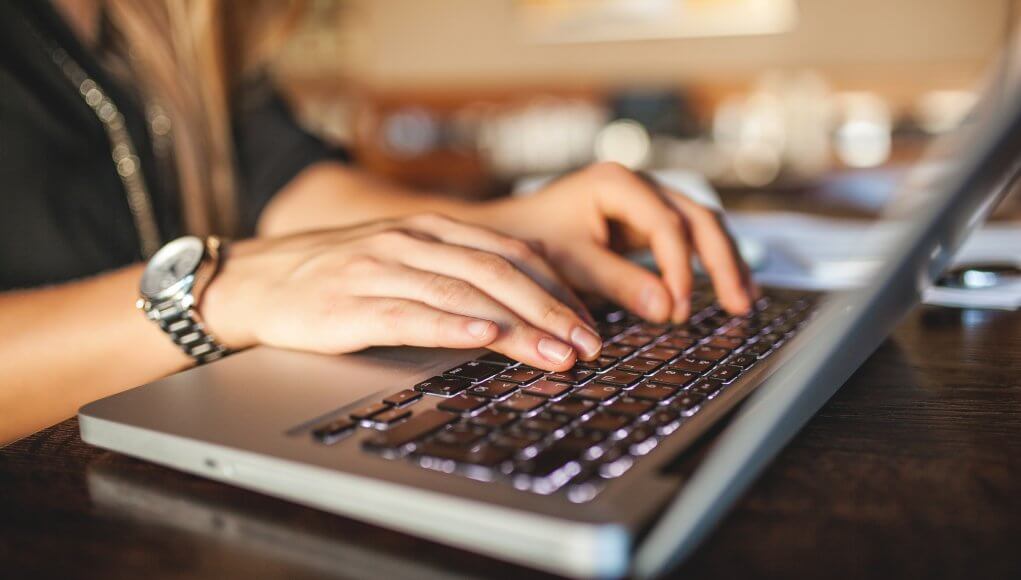 Person typing on Mac Pro Apple keyboard