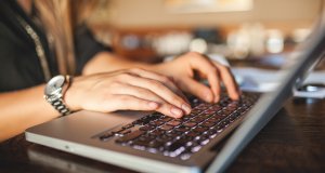 Person typing on Mac Pro Apple keyboard