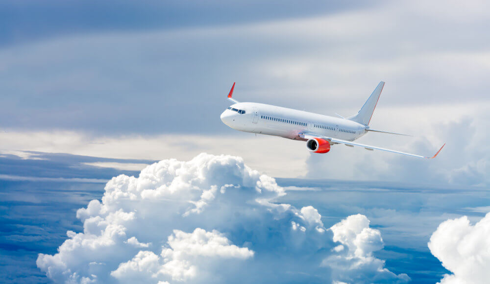 Airplane flying above clouds