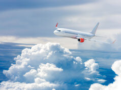 Airplane flying above clouds