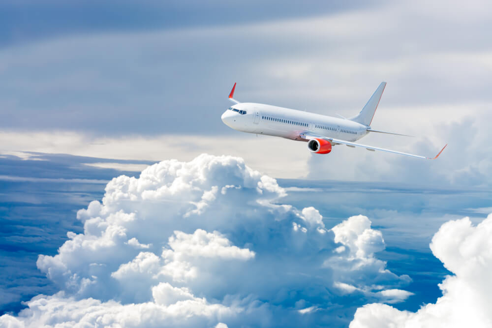 Airplane flying above clouds