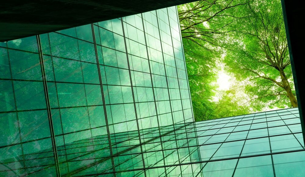 Eco-friendly building with tree branches concept; ESG goals and technology, cyber security 2023