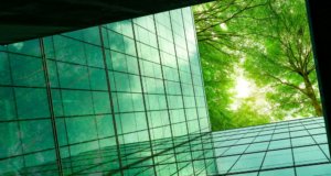 Eco-friendly building with tree branches concept; ESG goals and technology, cyber security 2023