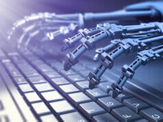 Robot typing on a computer