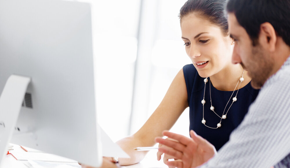 Business people looking at data in a modern office setting