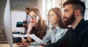 Information technology professionals looking at a computer