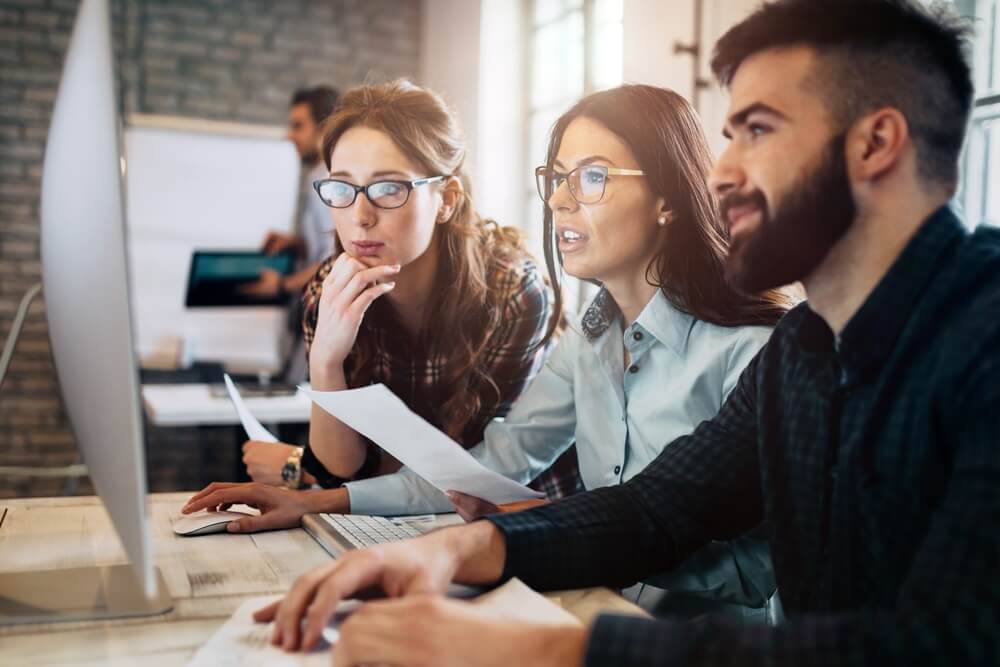 Information technology professionals looking at a computer