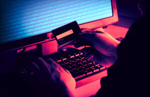 Hackers' hands reading a credit card