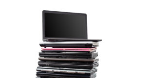 Stack of laptops in various colors and models