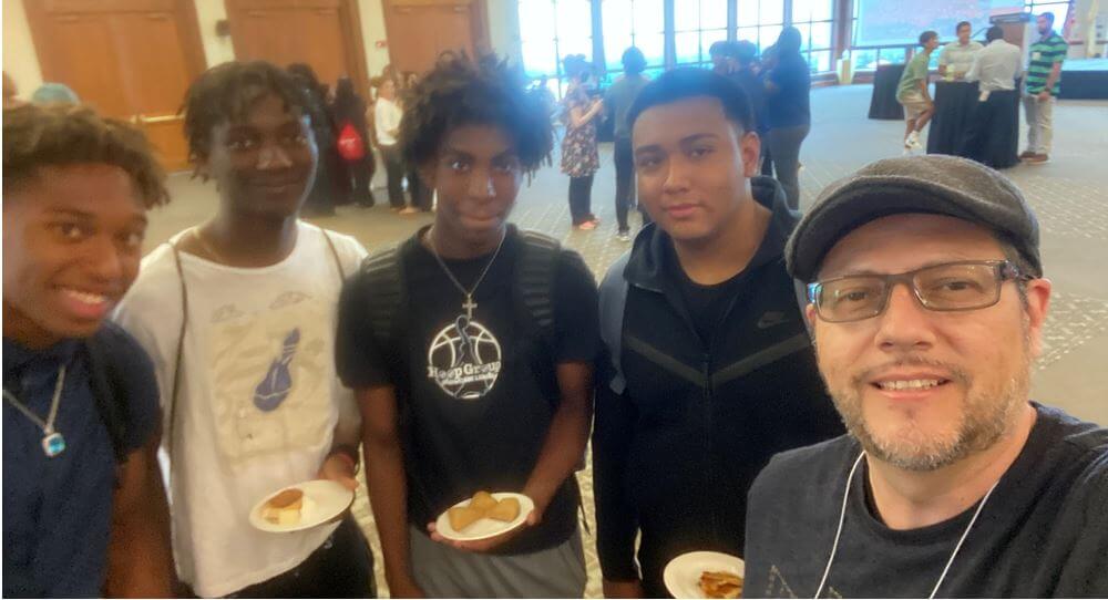 Miguel Angulo of Check Point Software Technologies takes a selfie with PCAI participants during a networking event