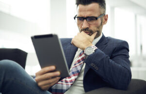 Portrait of a mindful business person reading something on a Tablet device